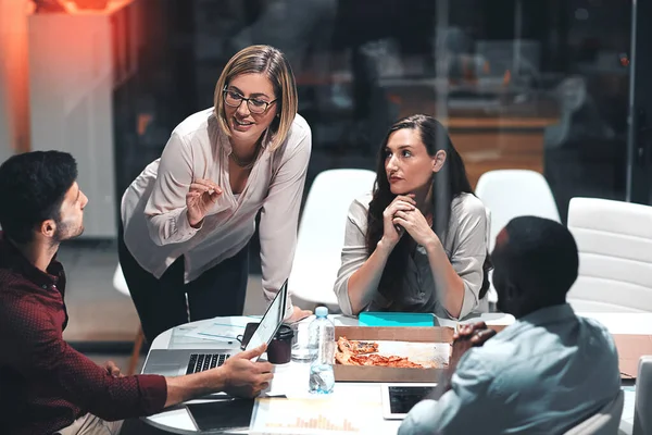 stock image Taking their dedication through the night. colleagues having a meeting during a late night in a modern office