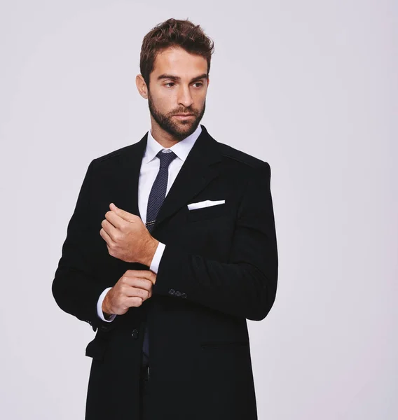 Business, thinking and man with ideas, suit and executive agent isolated against a grey studio background. Male person, thoughtful and entrepreneur with formal wear, trendy clothes and stylish outfit.