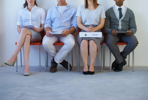 stock image Legs, recruitment and business people in line for job interview, hiring and waiting in a room. Human resources, meeting and candidates in a row in office for onboarding process at a startup company.