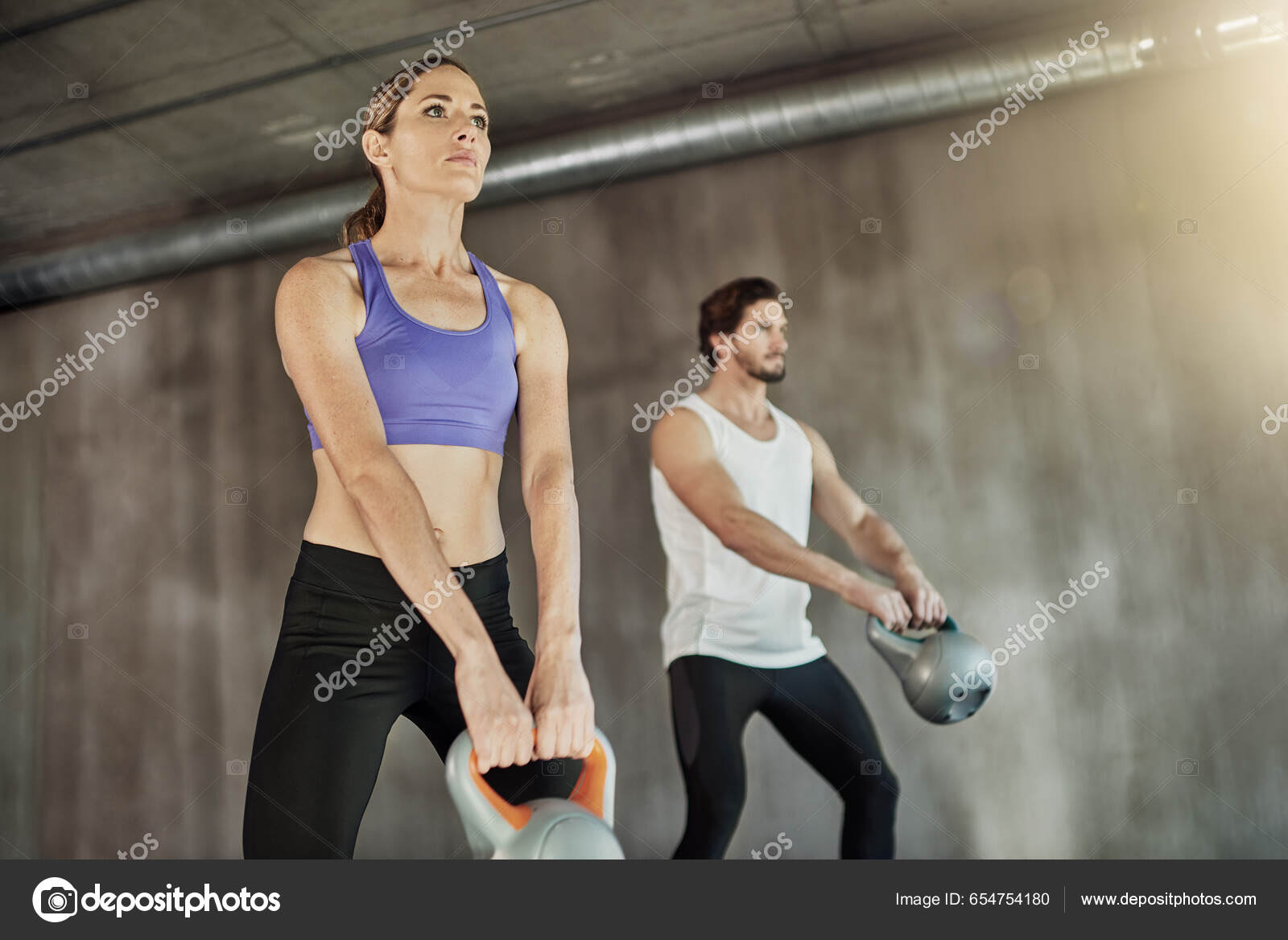 Muscular, sports man with female gym instructor or fitness coach