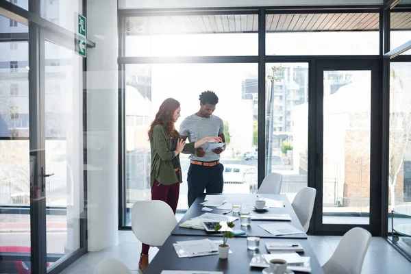 stock image Accessing a whole new world online. two young creatives working together on a digital tablet in a modern office