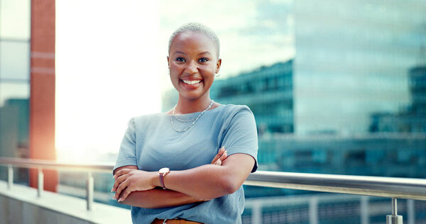 Black woman in city for business portrait while happy and arms crossed outdoor with vision and pride. Face of entrepreneur person with urban buildings and motivation for career goals as future leader.