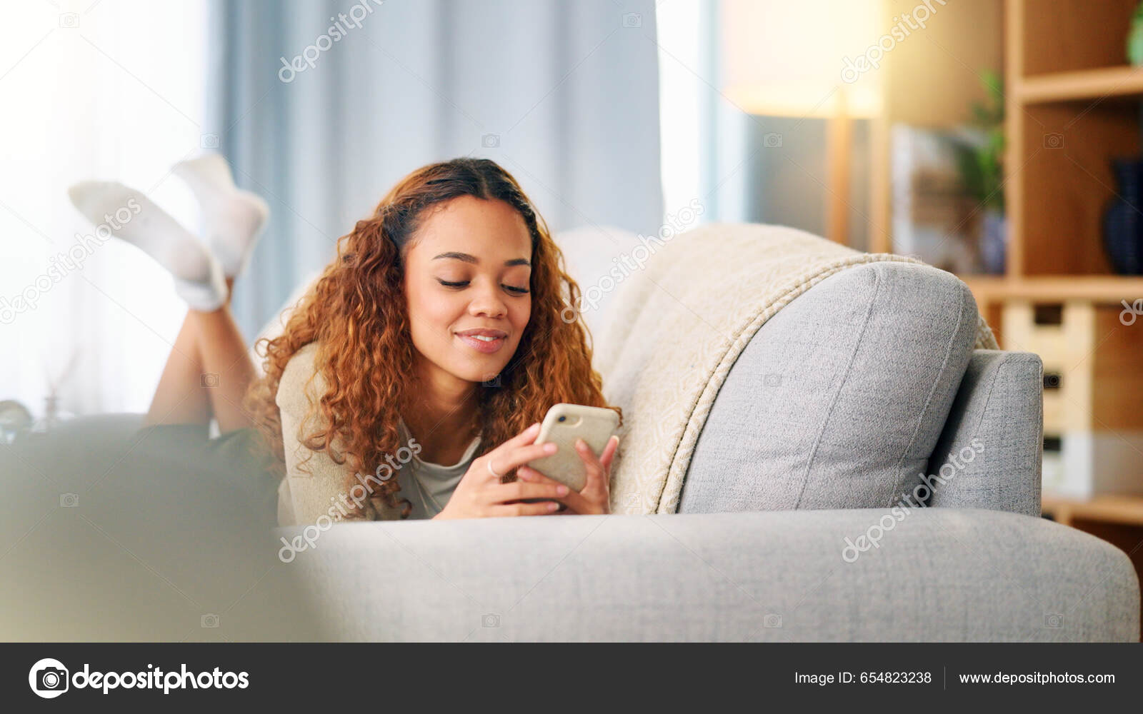 Young Woman Smiling Laughing While Texting Phone Home Cheerful Female —  Stock Photo © PeopleImages.com #654823238, image size:1600x1000