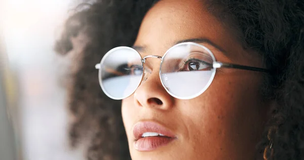 Closeup of thinking businesswoman wearing vision optometry glasses and looking confident, assertive and ready for success. Face of successful entrepreneur or visionary, proud of startup achievement.