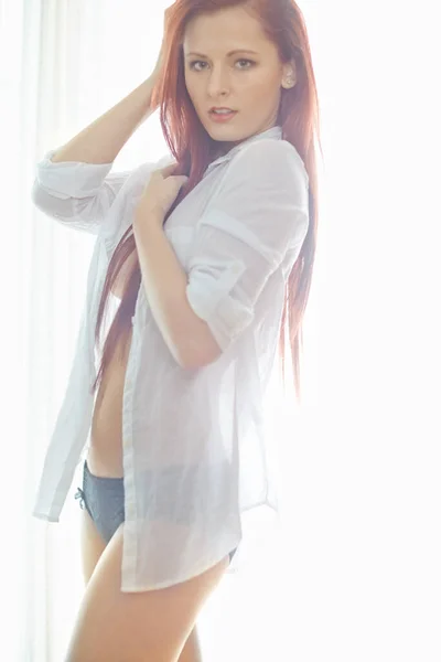Portrait Attractive Redheaded Woman Wearing Unbuttoned Shirt Standing Bedroom Looking — Stock Photo, Image