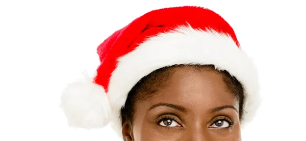クリスマスにしたいのはサンタの帽子をかぶった若い女性のスタジオショットと白い背景に対して思慮深く見えることだけです — ストック写真