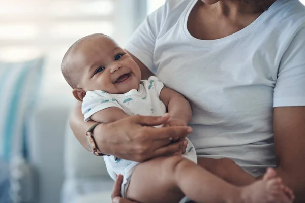 stock image A handful of happiness. a young woman carrying her adorable baby girl at home