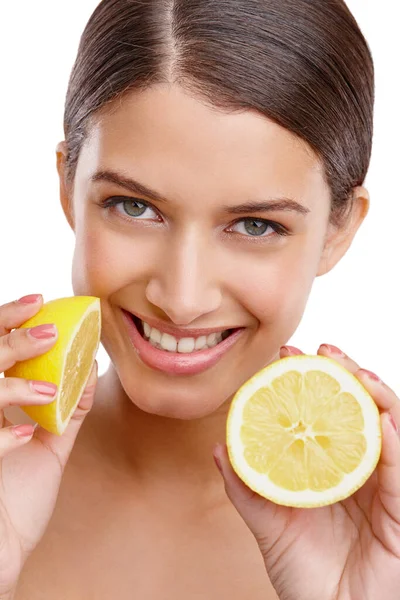 stock image Fresh skincare ideas. Studio portrait of a young woman holding up two halves of a lemon