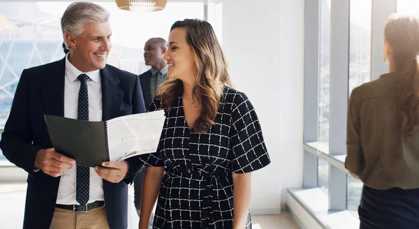 Stock image Everyone deserves to get recognition for their work. two businesspeople discussing something while walking together