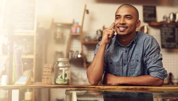 Smile, phone call and man with startup success, connection and communication for planning. Male person, happy employee and business owner with happiness, conversation and discussion in store and shop.