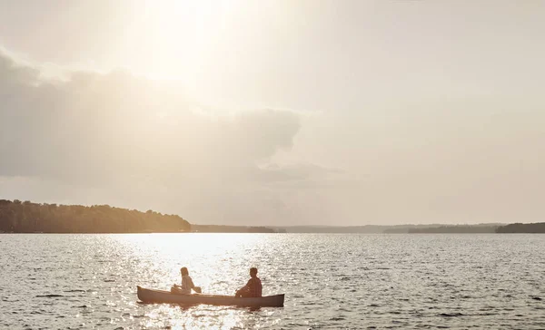 stock image Great idea to getaway on the lake. an unrecognizable couple rowing a boat out on the lake