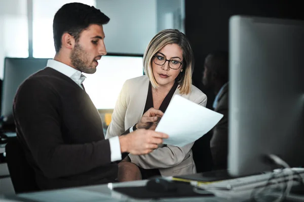 stock image Proving their value. two businesspeople discussing a document while sitting at a desk