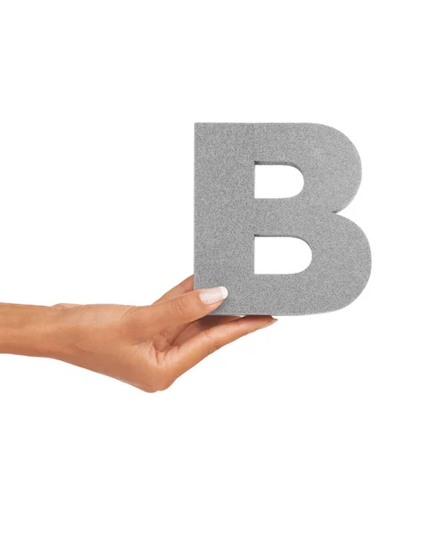 The letter B. A young woman holding a capital letter B isolated on a white background
