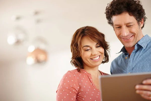 stock image Keeping their marriage modern. a husband and wife using a digital tablet together at home