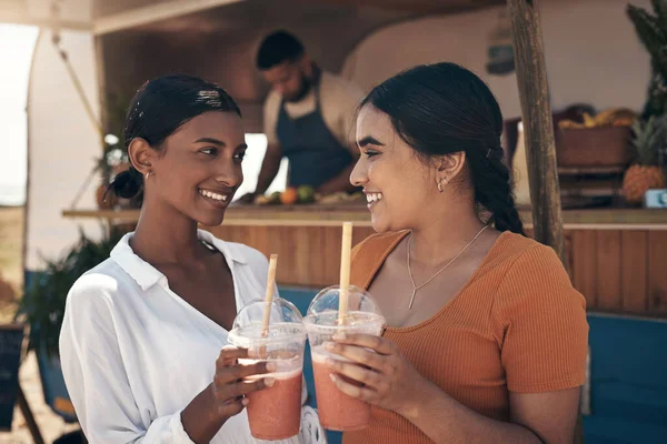 stock image Cheers to us darling. two friends enjoying smoothies together