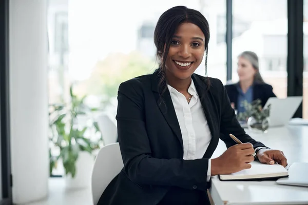 stock image Driving change takes a take charge attitude. a young businesswoman writing notes during a meeting in a modern office
