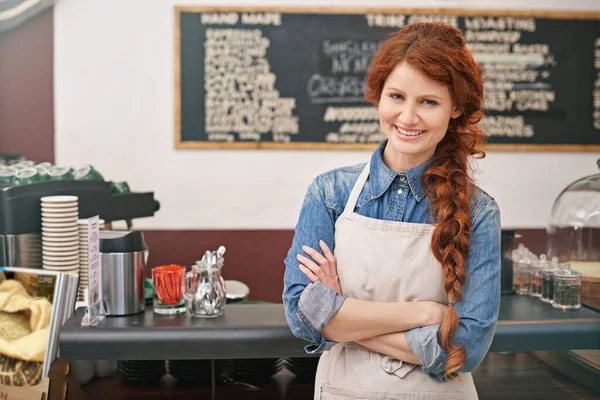 Portrait, woman and barista with arms crossed, coffee shop and startup success with skills. Face, female entrepreneur and employee with leadership, business development and profit growth in a cafe.