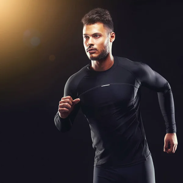 stock image Dont run away from challenges, run over them. Studio shot of a fit young man isolated on black