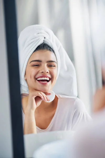 stock image I simply love the skin Im in. a beautiful young woman cleaning her face with cotton wool in the bathroom at home