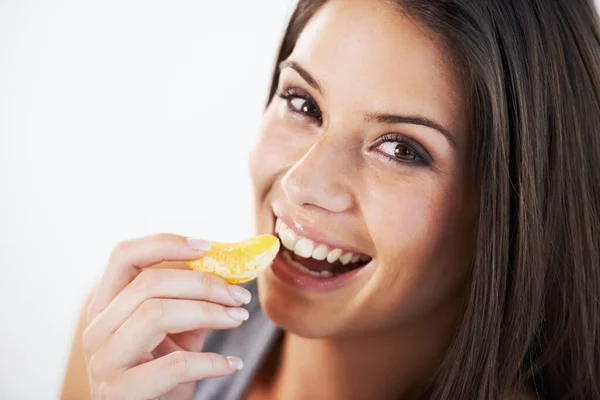 Stock image Bursting with citrus delight. Portrait of an attractive young woman eating fruit