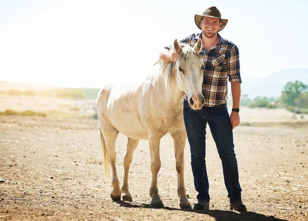 stock image Hes one of my biggest pets. a farmer standing with his horse