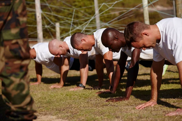 stock image Feeling the burn...a group of men doing push-ups at a military bootcamp
