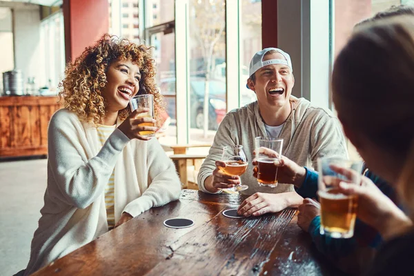 stock image Happy hour has never been more happier. a group of friends enjoying some beers at a bar