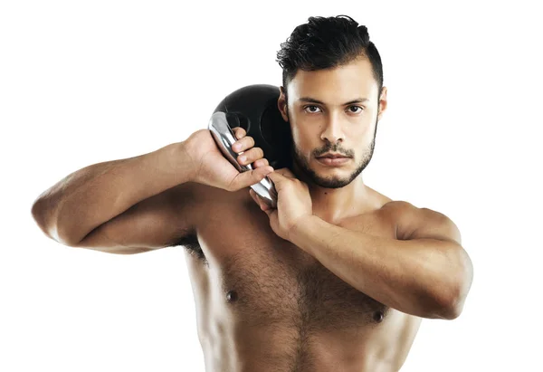 stock image Looking good takes effort. Studio shot of a fit young man working out with a kettle bell against a white background