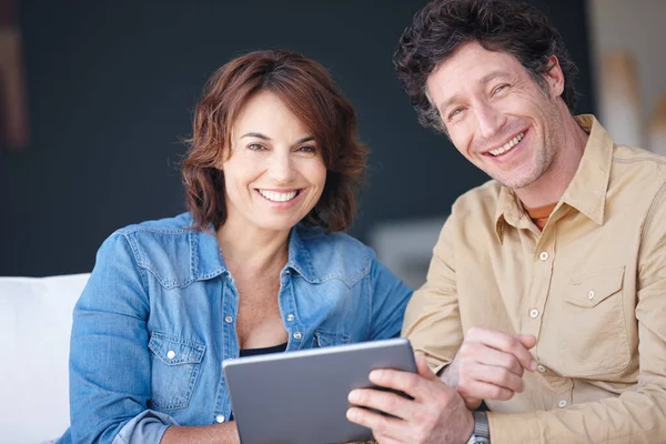 stock image Connected to life. a husband and wife using a digital tablet together at home