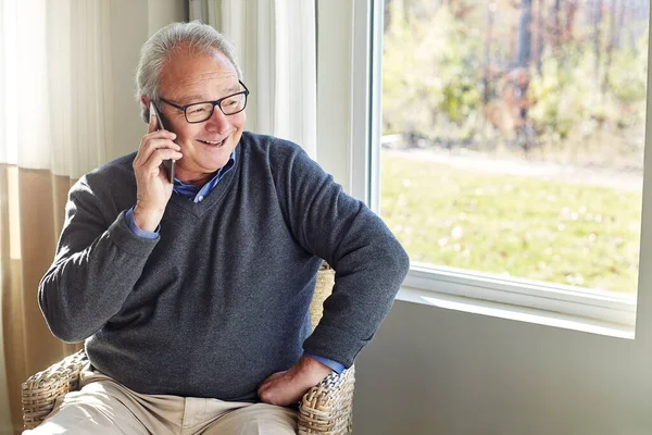 Stock image Im at home, youre welcome to join. a senior man on a call at home