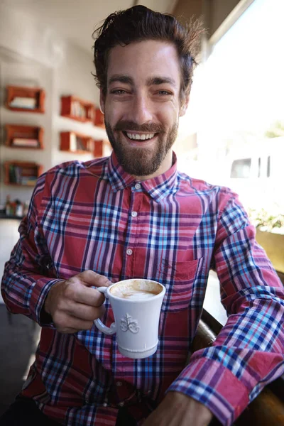 只要有足够的咖啡 什么都有可能 一个在咖啡店喝咖啡的年轻人 — 图库照片