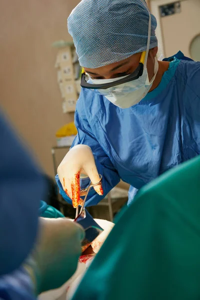 坚定的双手和坚定不移的集中精神是关键 在手术室里做手术的一组外科医生 — 图库照片
