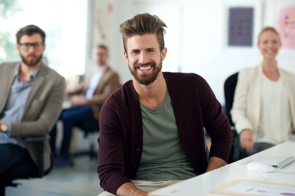 stock image Creative teams for successful solutions. Handsome young designer smiling at the camera in a shared office