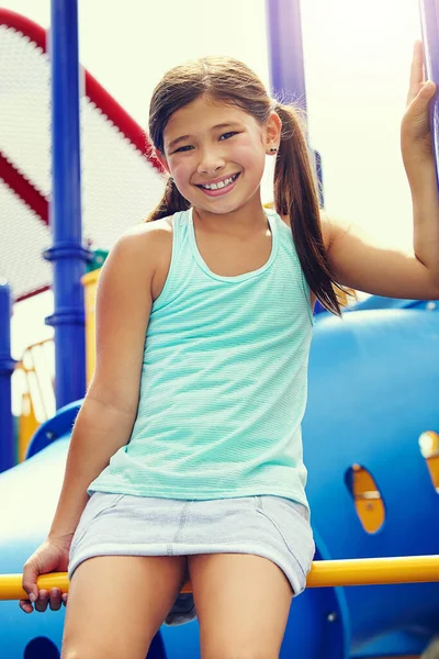 stock image Perched high on top of the jungle gym. a young girl playing on a jungle gym in the park