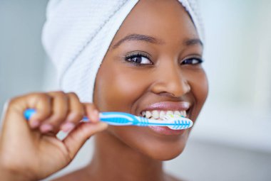 Because your pearly whites deserve to be pampered. a beautiful young woman during her daily beauty routine clipart