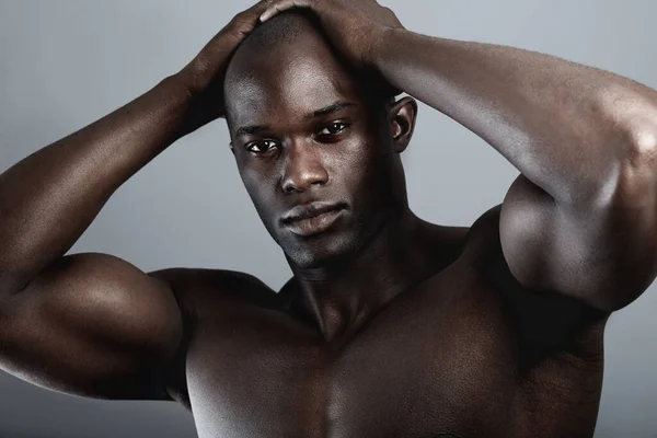 stock image Art, aesthetic and beauty, portrait of black man on dark background with muscle and hands on head. Health, wellness and sexy African bodybuilder or male model isolated on studio backdrop with power