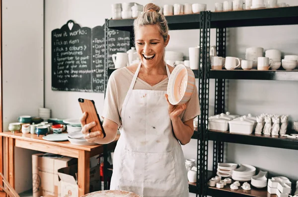 Happy woman, pottery and selfie in small business for social media, advertising or vlog at store. Female person or retail owner smiling with clay bowl for photo or online post on mobile smartphone.
