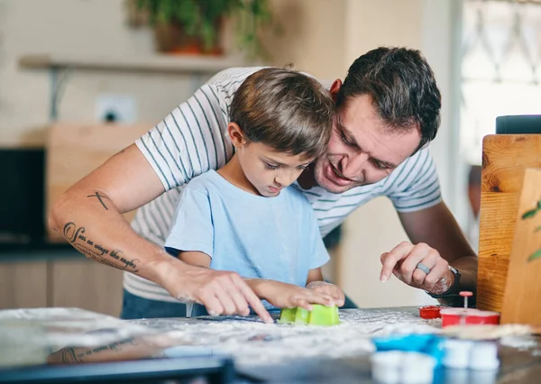 Stock image Carving out fun family memories. an adorable little boy baking with his father at home