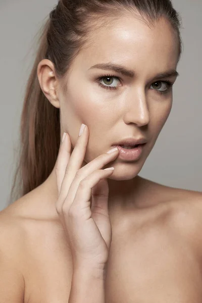 stock image Skincare, beauty and portrait of woman in studio for wellness, facial treatment and self care. Dermatology, spa and face of female person with natural cosmetics, makeup and glow on gray background.