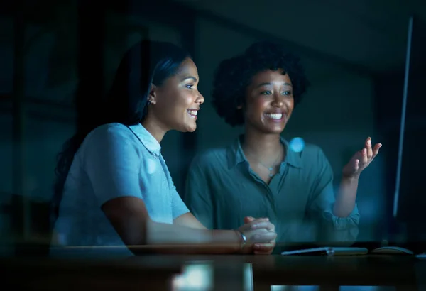 stock image Every move contributes to the bigger business masterpiece. two young businesswomen using a computer together during a late night at work