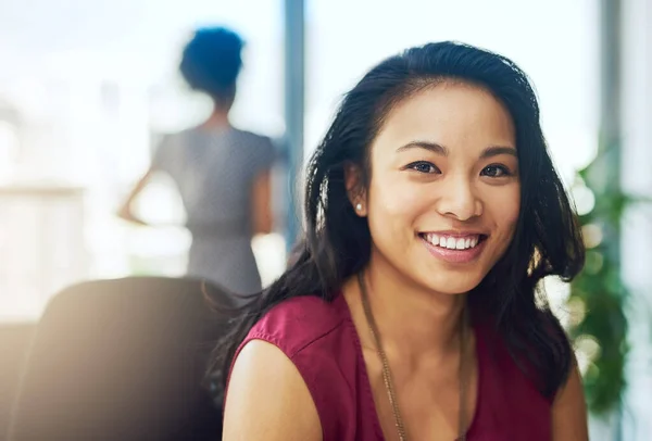 stock image Backed by motivation and ambition. Portrait of a young businesswoman sitting in a modern office