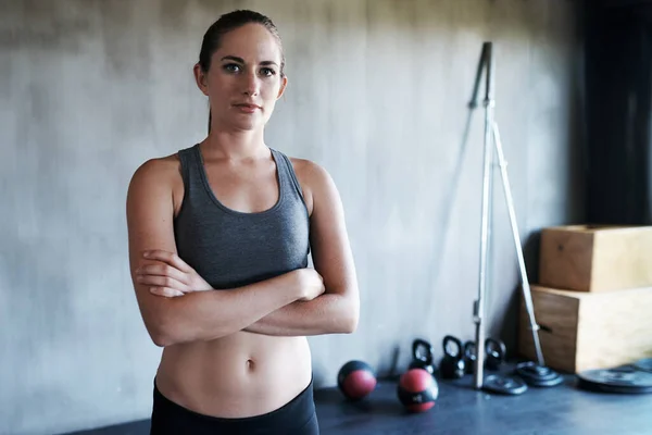 Stock image Serious woman, fitness and portrait with arms crossed in confidence for workout, exercise or training at gym. Strong, fit and confident active female in bodybuilding, healthy wellness and sports.