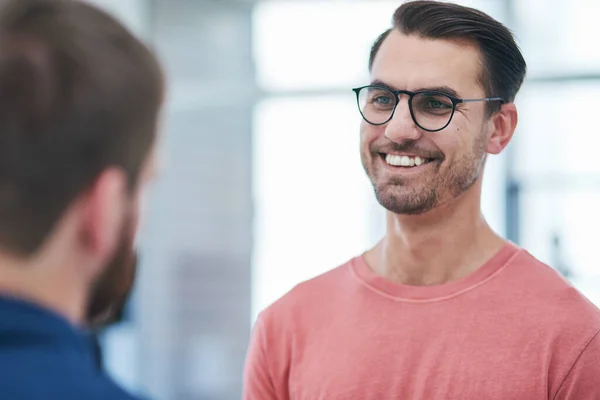 stock image The partnership thats geared up for company growth. two young businessmen having a conversation in a modern office