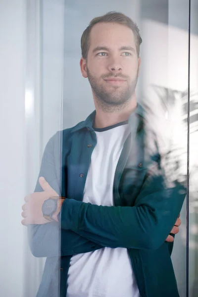 stock image Creative contemplation. a male designer lost in thought while standing in his office