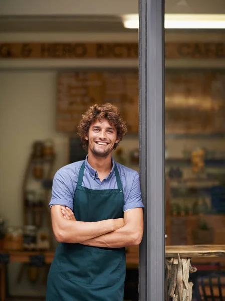 Owner, arms crossed or portrait of man at restaurant for small business, coffee shop or waiter. Entrepreneur, happy smile and male barista at front door of cafe for diner and food industry confidence.