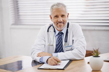 Healthcare, portrait and male doctor with a clipboard in his office analyzing xray document in hospital. Confidence, smile and professional mature man medical worker with paperwork by desk in clinic clipart