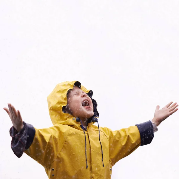 Girl child, rain and playing with space for mockup with shouting, happiness or winter fashion. Female kid, raincoat or playful with water, open hands or screaming on adventure with freedom in mock up.