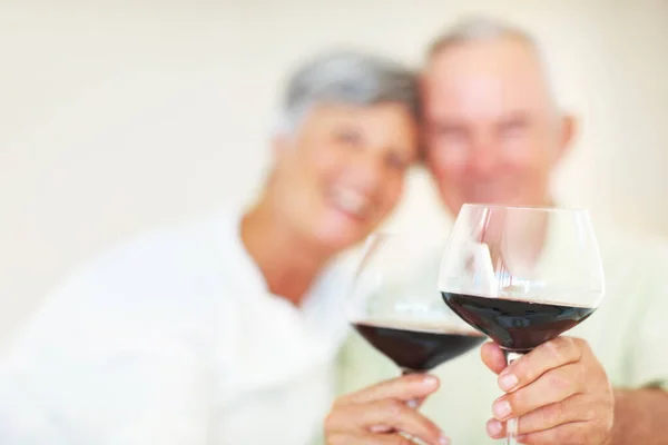 ワインで熟成させたカップルトースト 乾杯で祝う素敵な成熟したカップルの肖像 ワイングラスに焦点を当てます — ストック写真