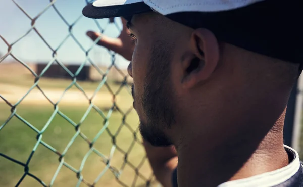 如果他不玩 他就在看 一个从栅栏后面看棒球比赛的年轻人 — 图库照片