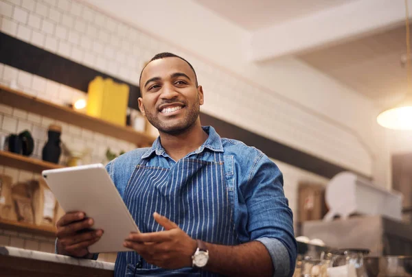 Happy, tablet and waiter with man in cafe for online, entrepreneurship and startup. African, technology and food industry with small business owner in restaurant for barista, network and coffee shop.